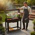 Asia Trade professional Argentina style charcoal grill with V-shaped stainless steel grate, lifting mechanism, and wheels.