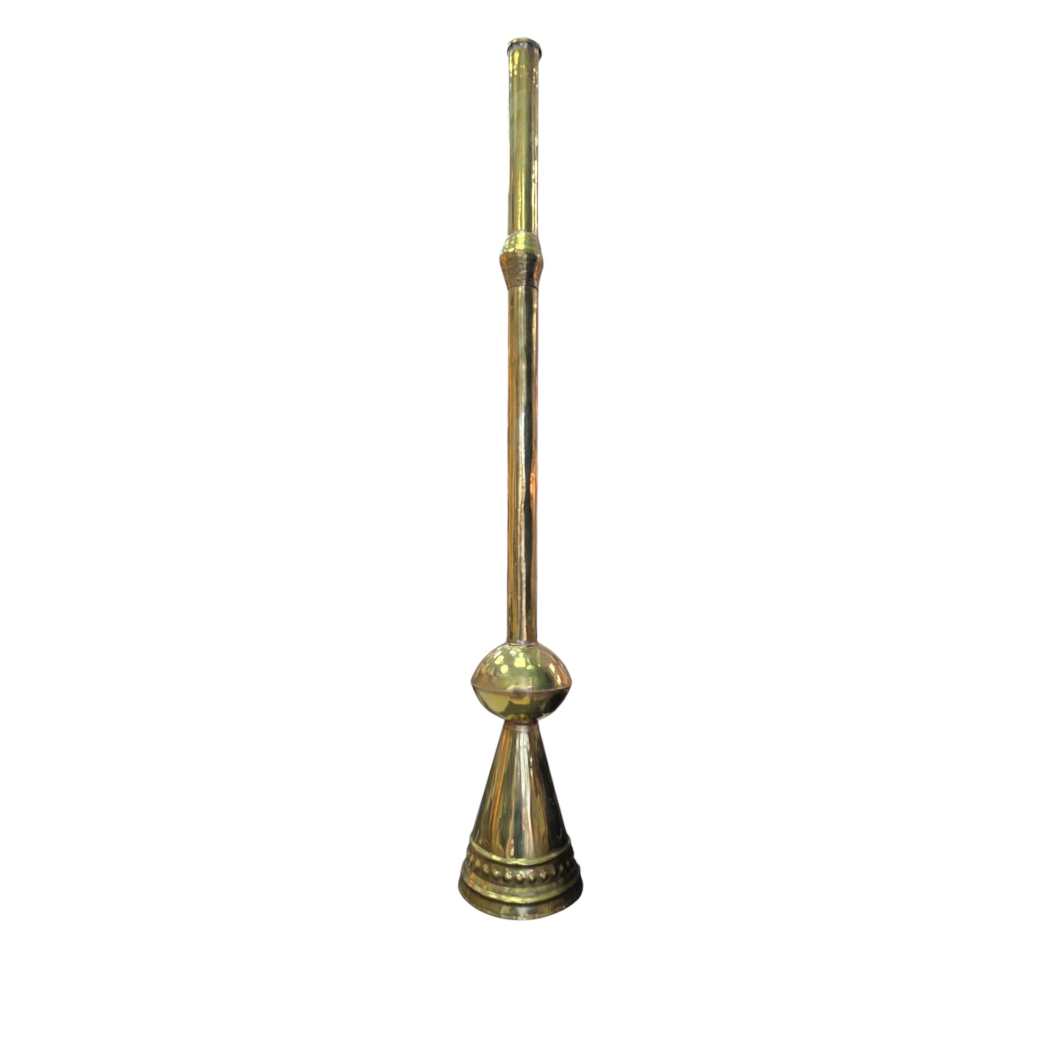 Asia Trade traditional brass Karnay trumpet with a long slender neck and wide bell base standing in a retail store.