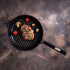 Asia Trade BRIZZOL cast iron grill pan with wooden handle, featuring a seared steak, mushrooms, and cherry tomatoes.