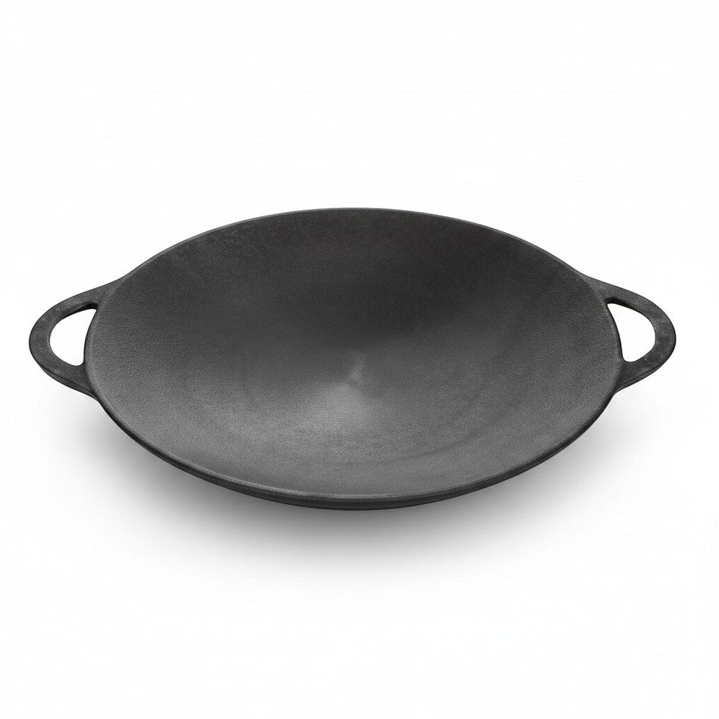 Asia Trade 40cm cast iron saj pan for open fire cooking, featuring a durable black surface and two side handles.