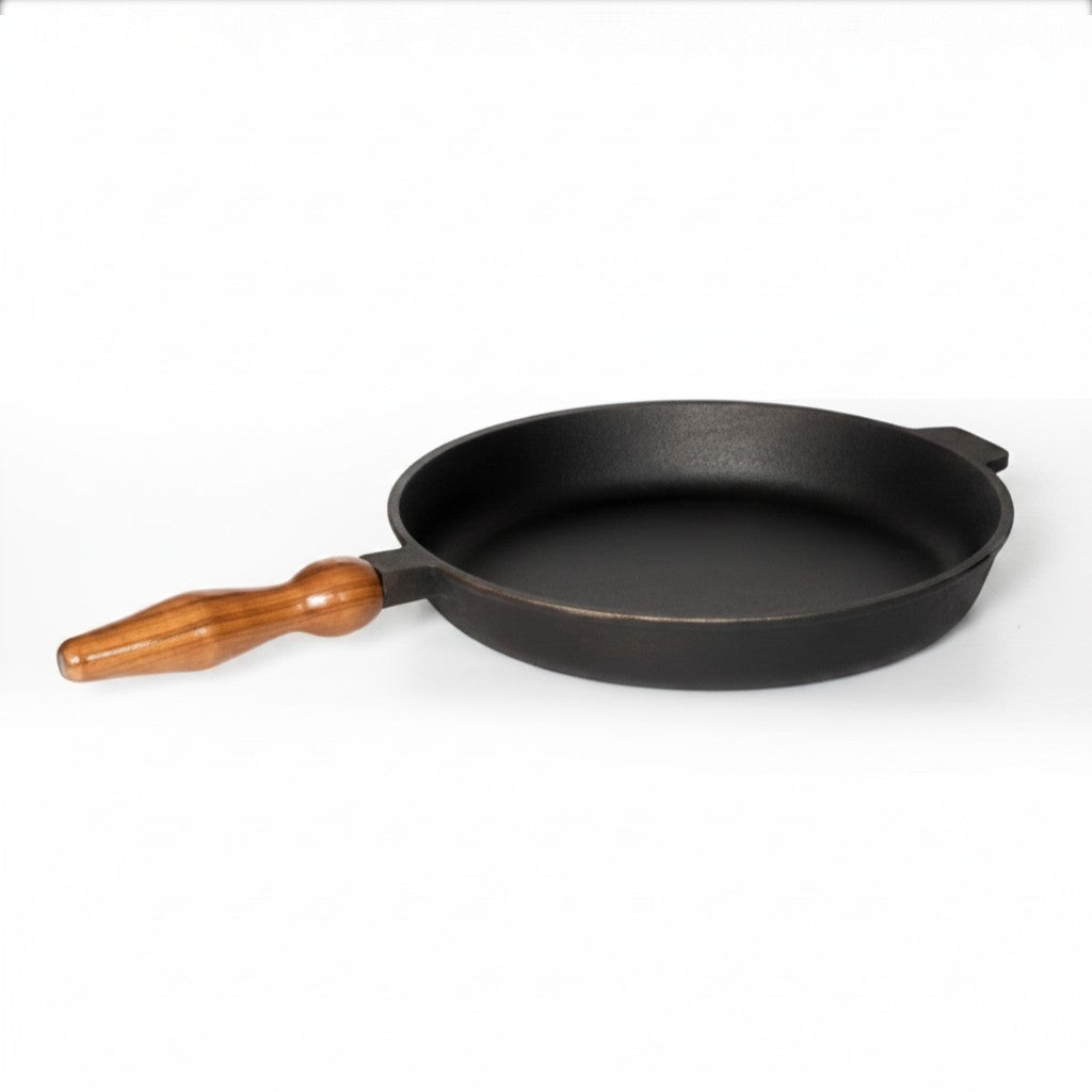 Asia Trade 28cm cast iron skillet with a wooden handle, suitable for induction, open fire, and oven cooking.