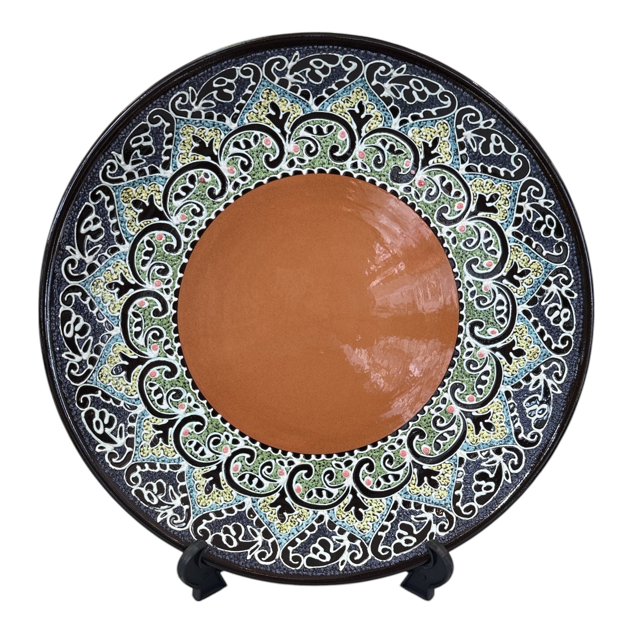 Asia Trade 32cm decorative ceramic plate featuring a solid terracotta center and intricate black, green, and white floral patterns.