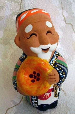 Asia Trade handcrafted clay figurine of an old man holding bread, featuring traditional Uzbek colorful patterns.