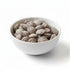 Asia Trade roasted apricot kernels from Uzbekistan in a white bowl, lightly salted and charcoal roasted.