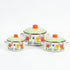 Asia Trade set of three white enamel pots with floral butterfly patterns and orange lids in varying sizes